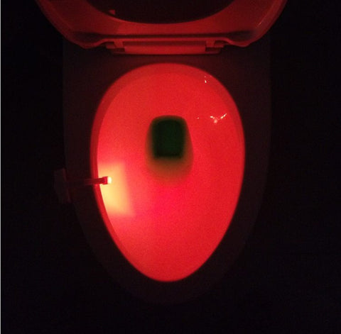 Red LED glow from Toilet Induction Night Light illuminating toilet bowl, enhancing safety and convenience during nighttime use.