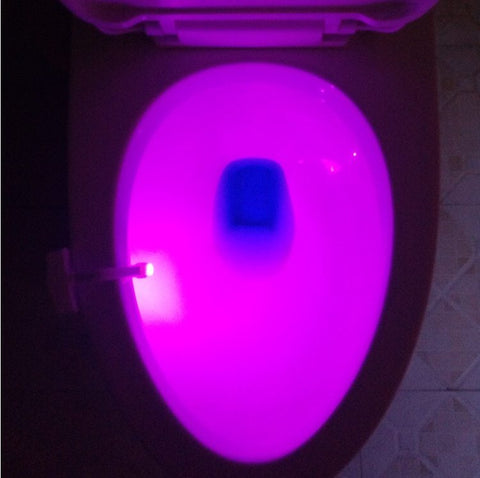 Toilet Induction LED Night Light casting vibrant purple light inside toilet bowl, perfect for modern bathroom ambiance and visibility.