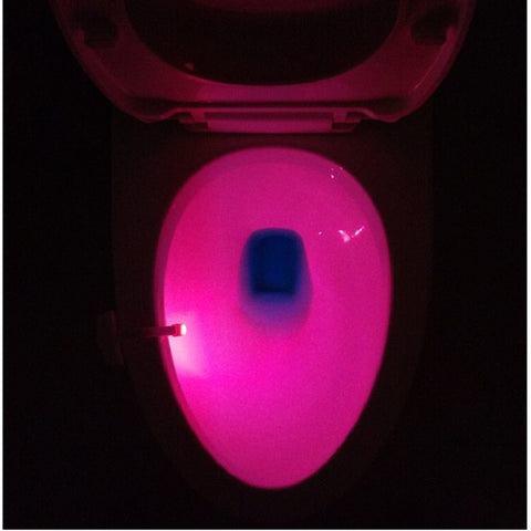 Toilet Induction LED Night Light illuminating toilet bowl in bright pink, enhancing visibility at night with motion-activated LED lighting.