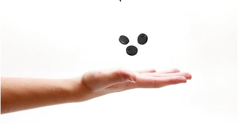 Three HDQ15 Home Surveillance Cameras 1080P floating above an open hand, showcasing lightweight and minimalistic design for home monitoring.