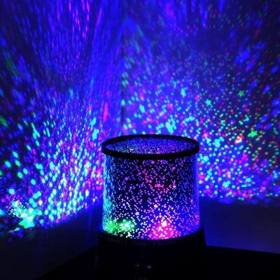LED Star Night Light Projector casting colorful starlight patterns on walls and ceiling. Ideal for kids' bedrooms and nighttime ambiance.