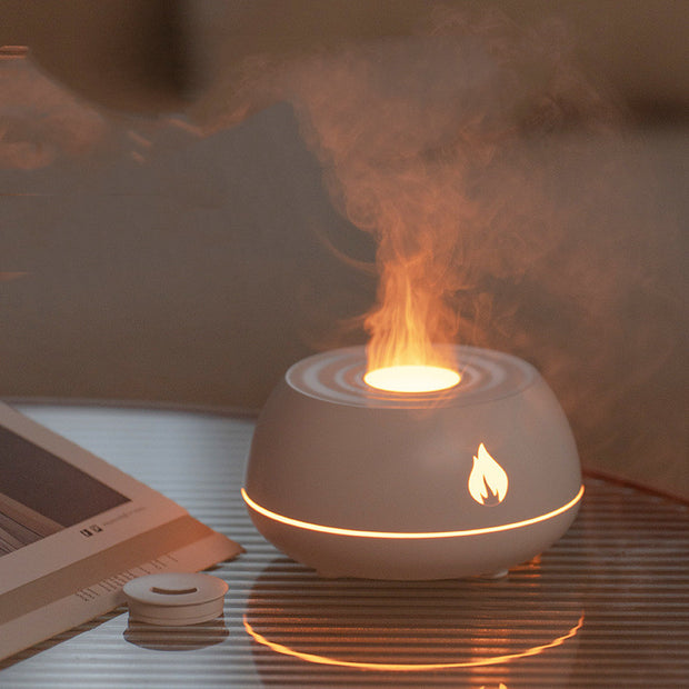 Flame Aromatherapy USB Diffuser on a table with glowing flame effect and mist, enhancing a cozy sleep environment.