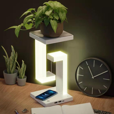 Wireless Charging Floating Lamp used as a plant stand, phone charging on base, stylish multifunctional lighting for home decor.