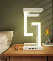Wireless Charging Floating Lamp on nightstand, LED light on, perfect for stylish bedroom lighting and phone charging.