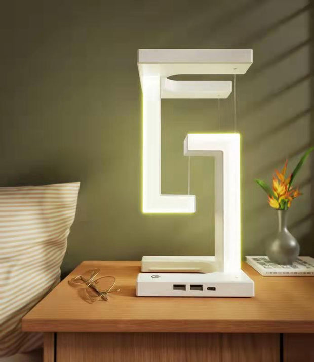 Wireless Charging Floating Lamp on nightstand, LED light on, perfect for stylish bedroom lighting and phone charging.