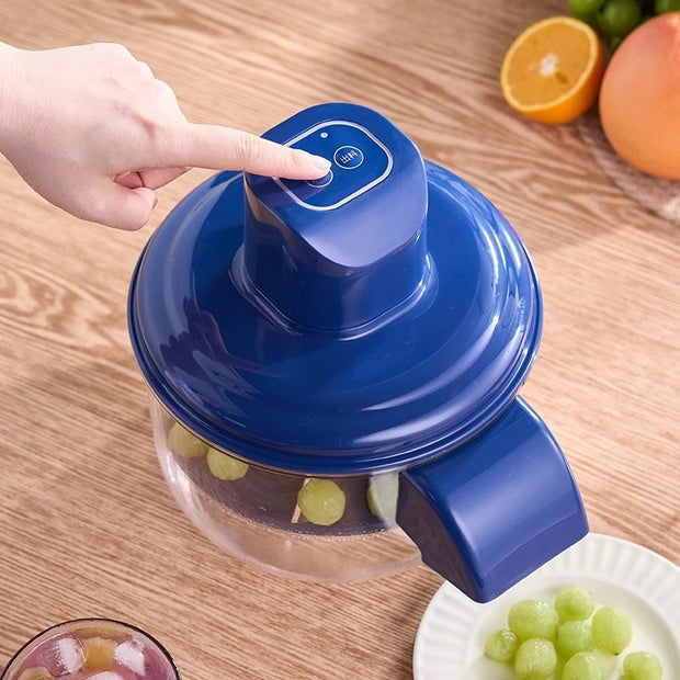 User pressing button on Automatic Electric Grape Peeler with peeled grapes inside, emphasizing one-click ease and kitchen gadget utility.