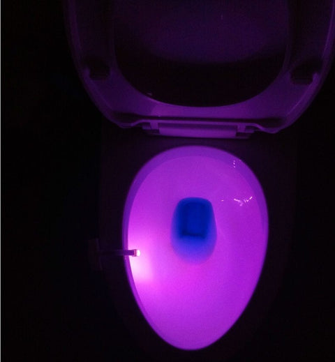 Purple glow from Toilet Induction LED Night Light inside toilet bowl, offering stylish and functional night lighting with motion detection.