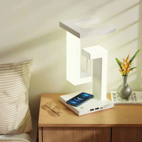 Wireless Charging Floating Lamp on bedside table with phone charging, sunlight casting shadows, modern multifunctional decor.