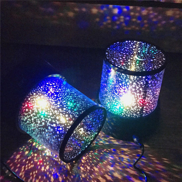 Colorful LED Star Night Light Projectors on a dark surface, projecting vibrant starlight. Enhances kids’ rooms with a galaxy-like atmosphere.