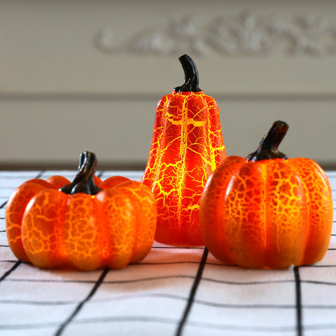 Set of three Halloween Pumpkin LED Lanterns with crackled design on checkered surface, ideal for festive table centerpieces and decor.