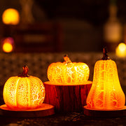 Brightly lit Halloween Pumpkin LED Lanterns on wooden stands, simulating real pumpkins for cozy seasonal ambiance and outdoor displays.