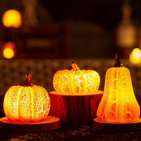Brightly lit Halloween Pumpkin LED Lanterns on wooden stands, simulating real pumpkins for cozy seasonal ambiance and outdoor displays.