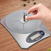 Mini Kitchen Scale Digital Weighing in silver with a round glass platform, showing precision weight measurement using a calibration weight.