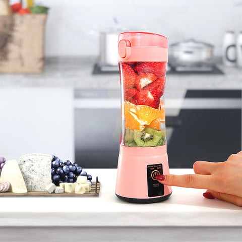 Pink portable USB smoothie blender in kitchen setting, blending fresh fruits with one-touch operation for easy use.
