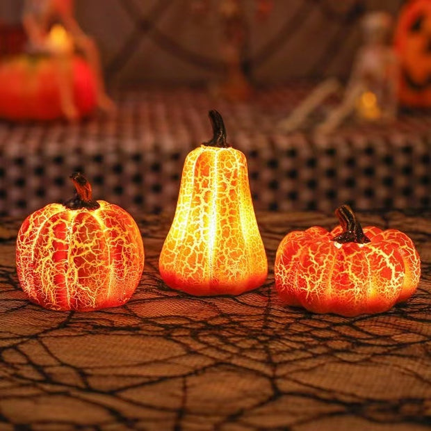 Glowing Halloween Pumpkin LED Lanterns on spiderweb tablecloth, simulating real pumpkins for eerie and festive Halloween ambiance.
