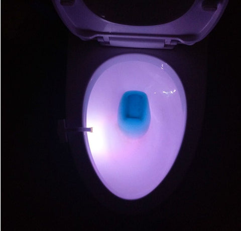 Soft white glow from Toilet Induction LED Night Light inside toilet bowl, motion-activated for energy-efficient nighttime lighting.