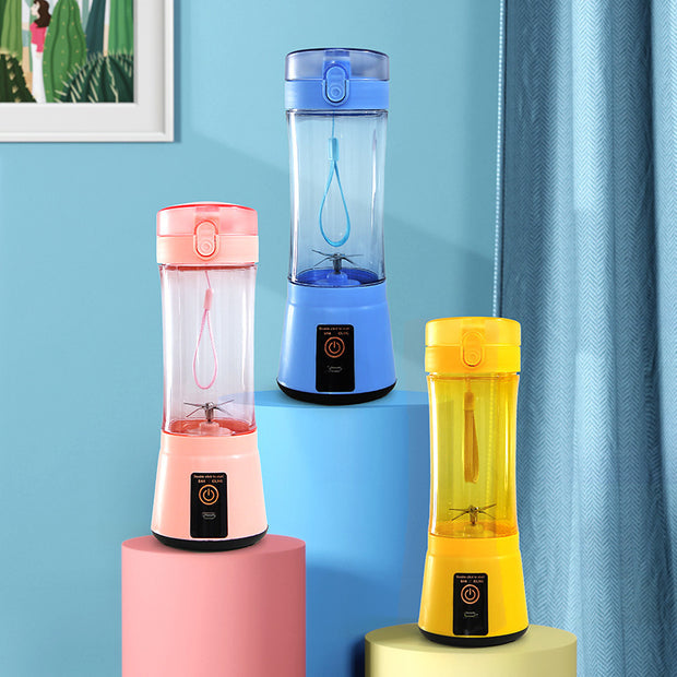 Three colorful USB rechargeable mini blenders displayed on pedestals, showcasing stylish and compact kitchen appliances.