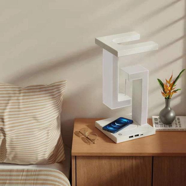 Wireless Charging Floating Lamp beside bed with phone charging, soft LED glow enhances modern bedroom ambiance.