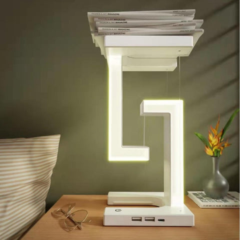 Wireless Charging Floating Lamp on bedside table with magazines on top, combining storage, lighting, and wireless charging.