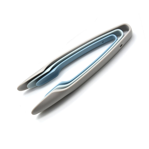 Silicone kitchen tongs in light grey and blue, ideal for use with the Smart Touch Air Fryer to safely handle hot food.