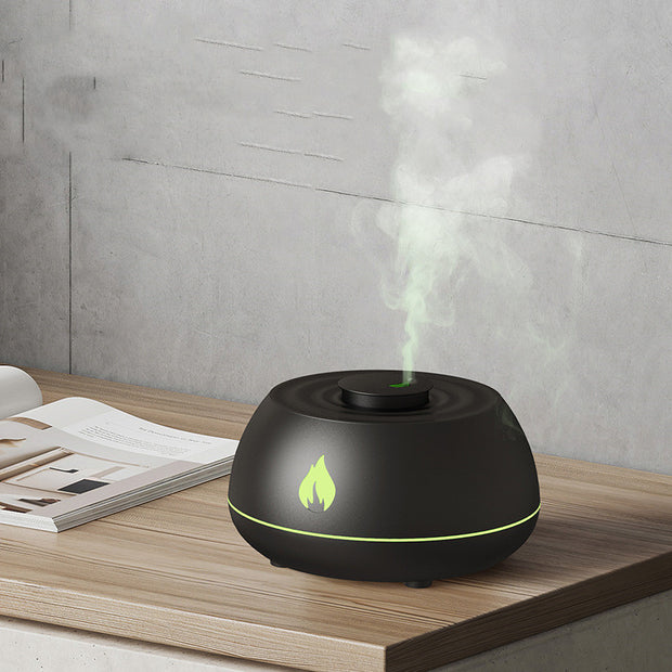Black Flame Aromatherapy USB Diffuser releasing green mist, ideal for essential oil diffusion and nighttime ambiance.