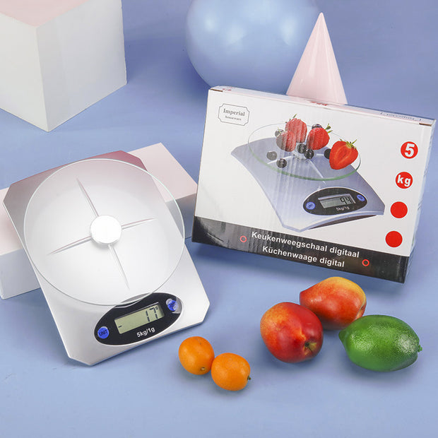 Battery-powered Mini Kitchen Scale Digital Weighing with packaging and fruits, ideal for accurate food portioning in modern kitchens.